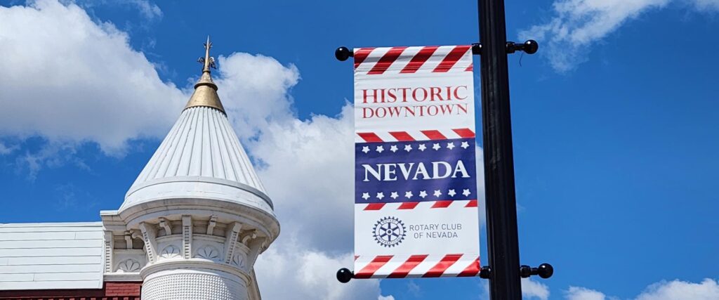 Sponsored Banner hanging on a light pole in Nevada Main Street